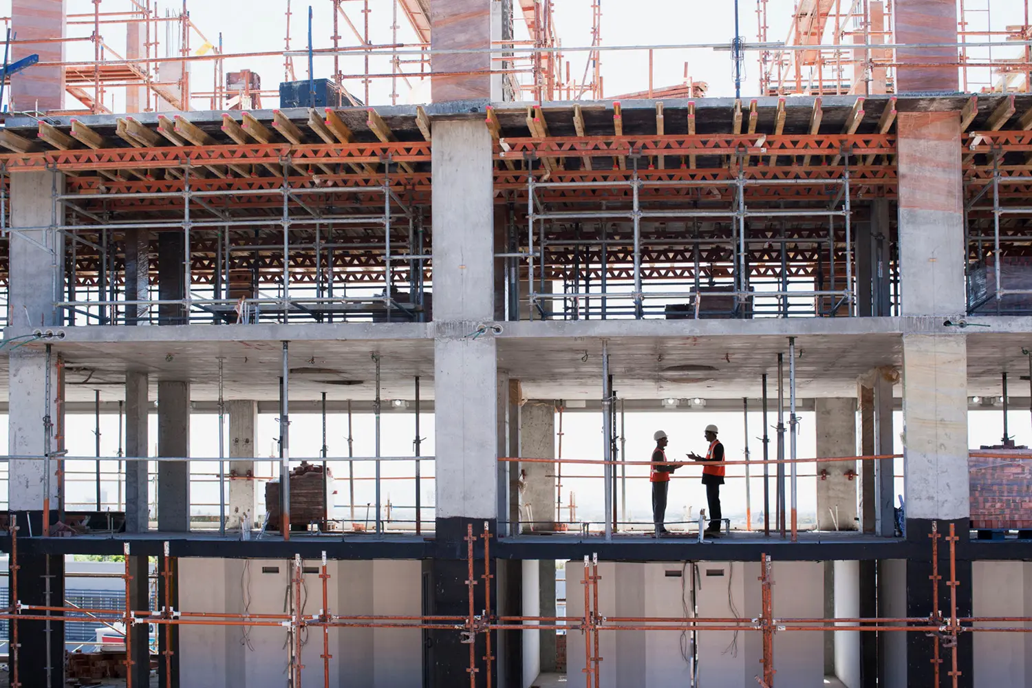 Construction workers on a multi-story building site.