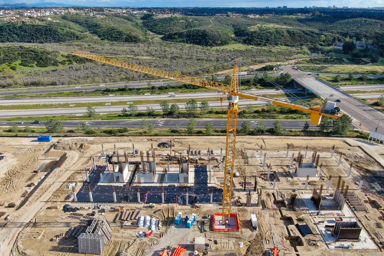 Construction site with crane and building foundation.