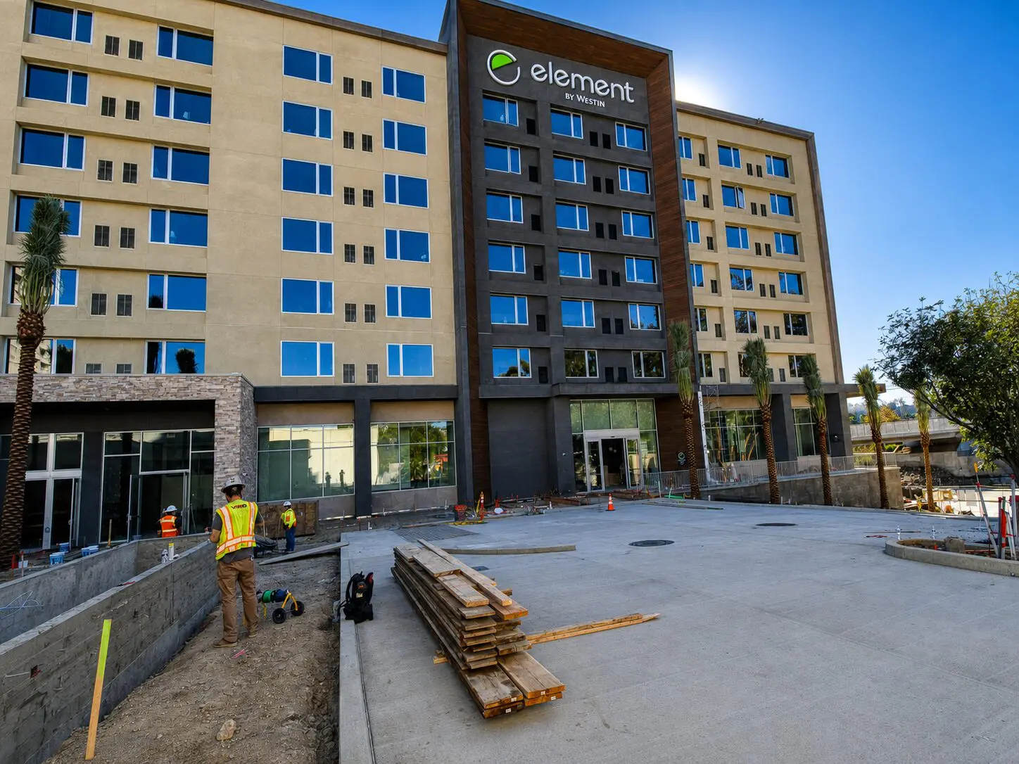 Hotel exterior under construction with workers