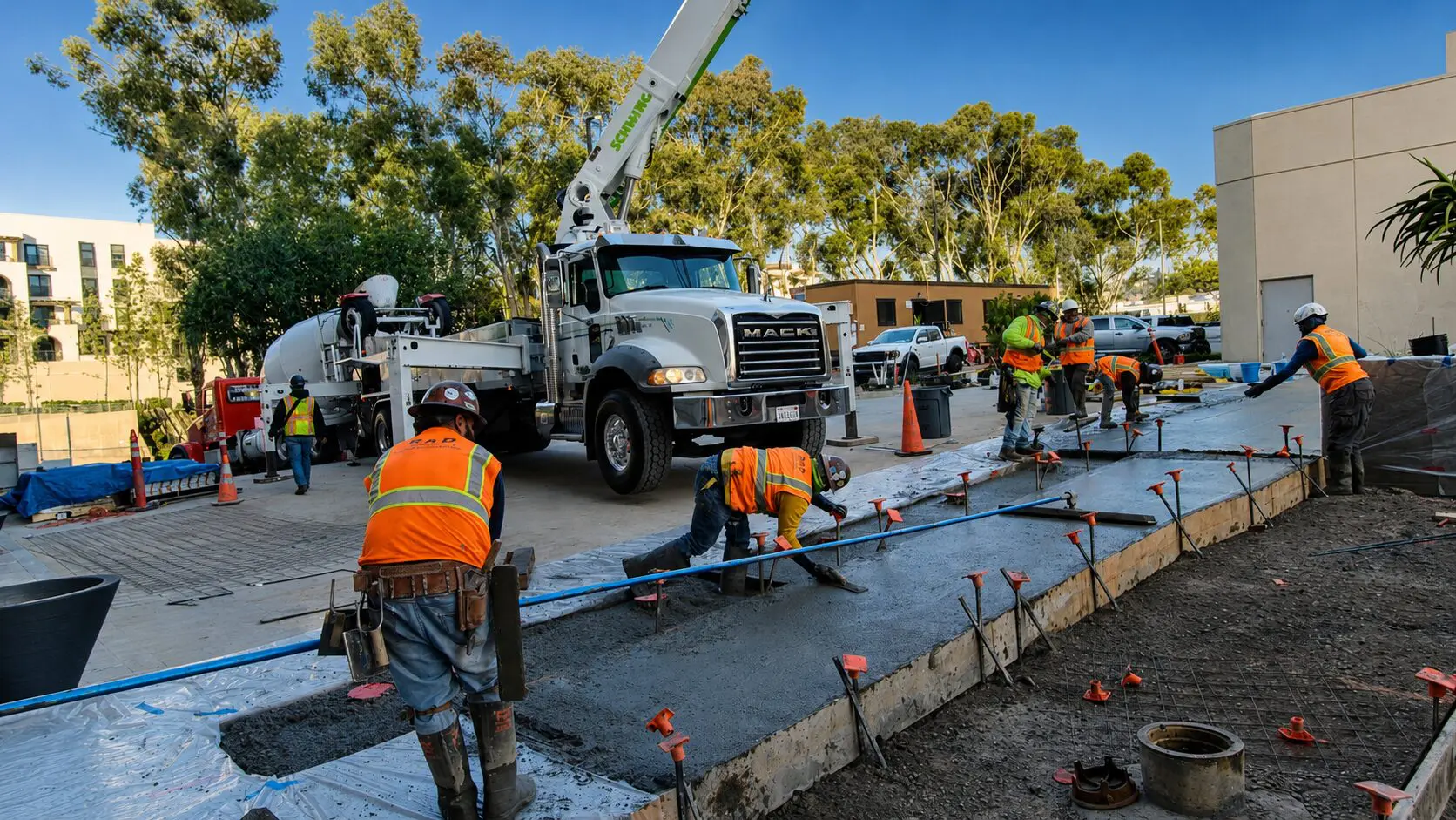 Construction workers pouring concrete at site
