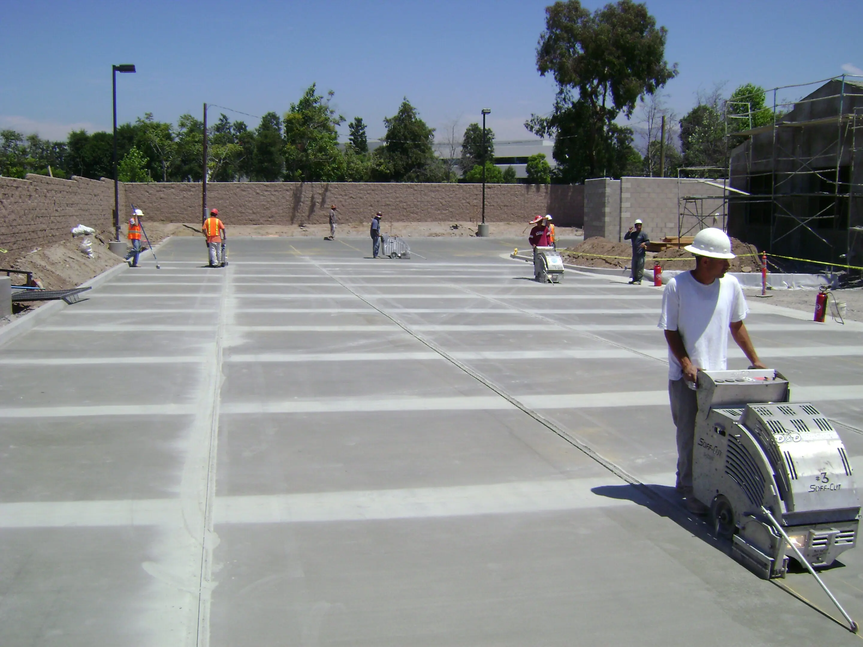 Team operating machinery on concrete site