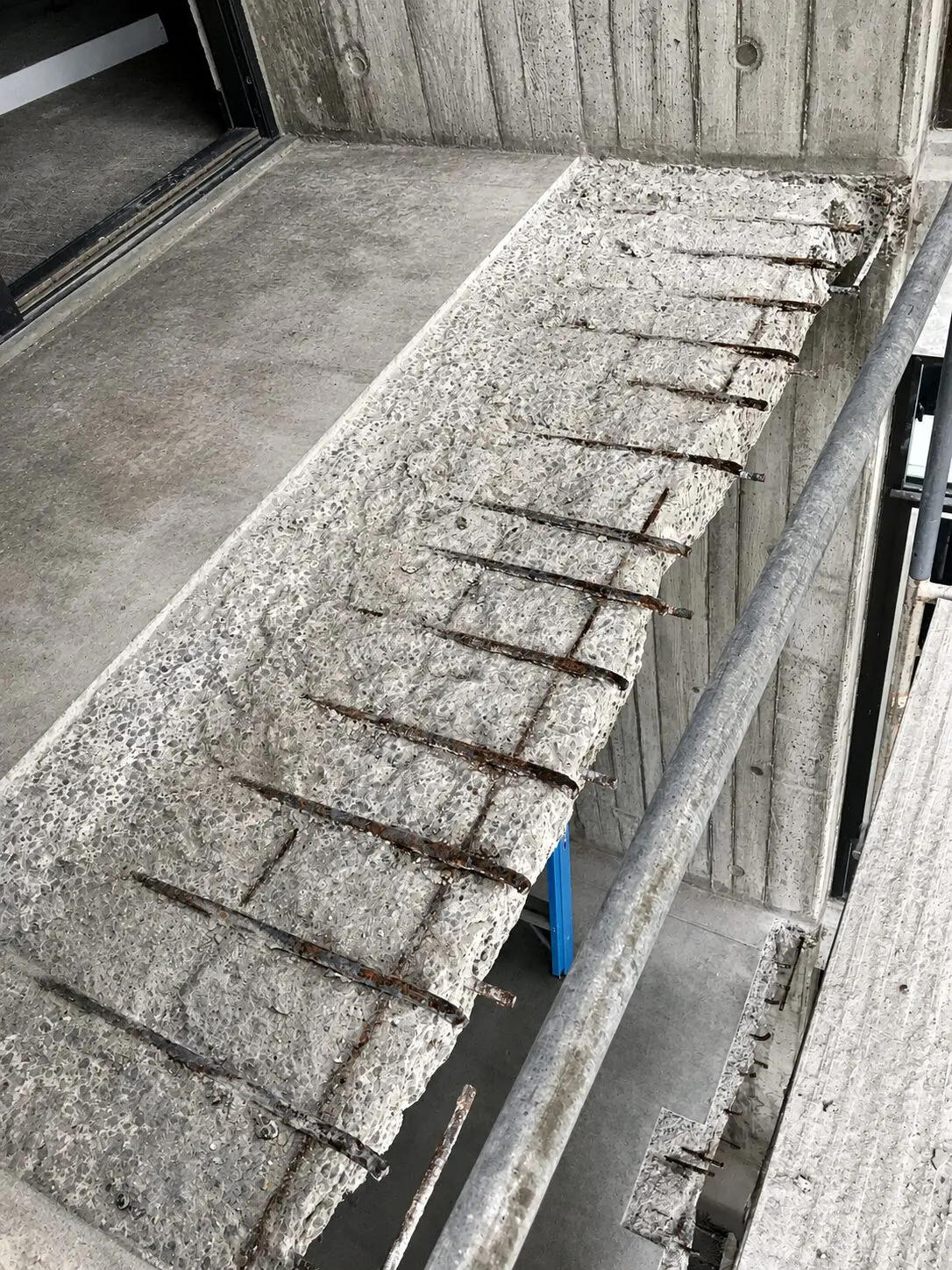 Balcony showing erosion and rusted reinforcement