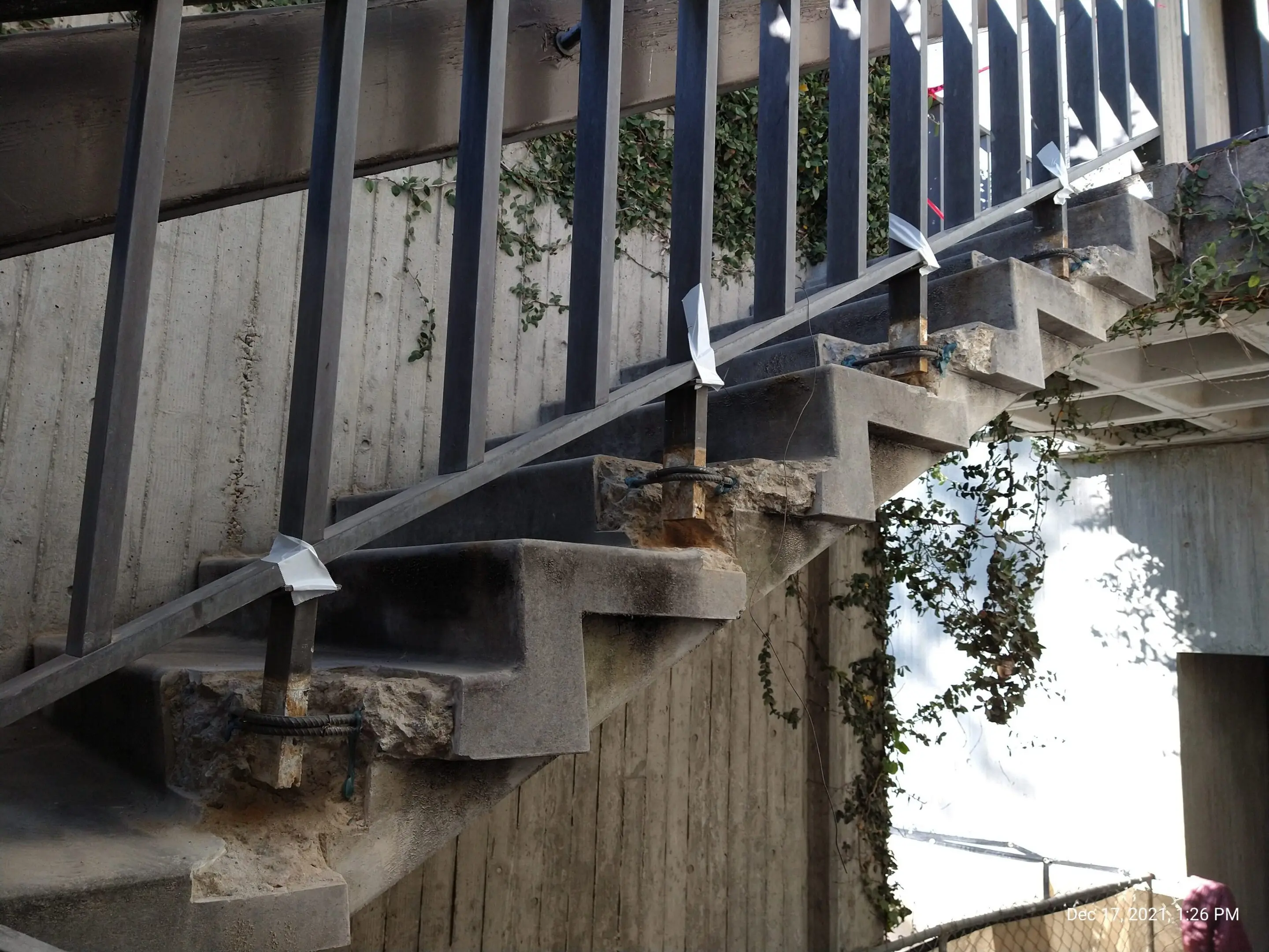 Damaged concrete staircase with exposed rebar
