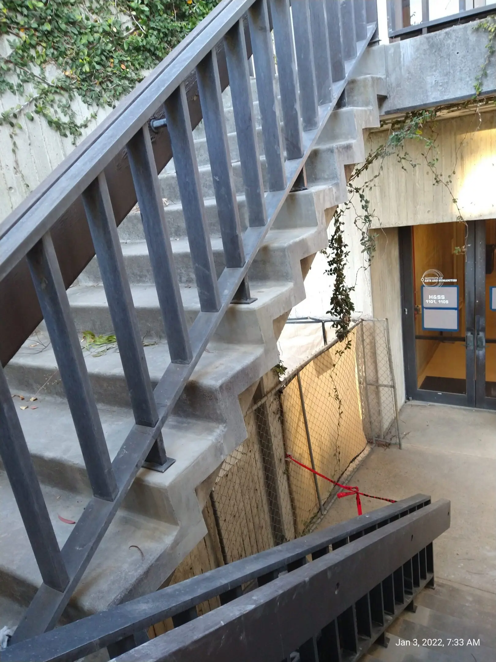 Concrete staircase with metal railing