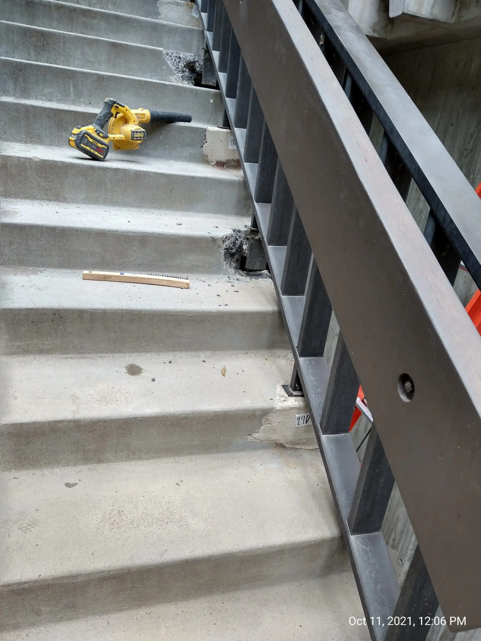 Damaged concrete stairs with tools