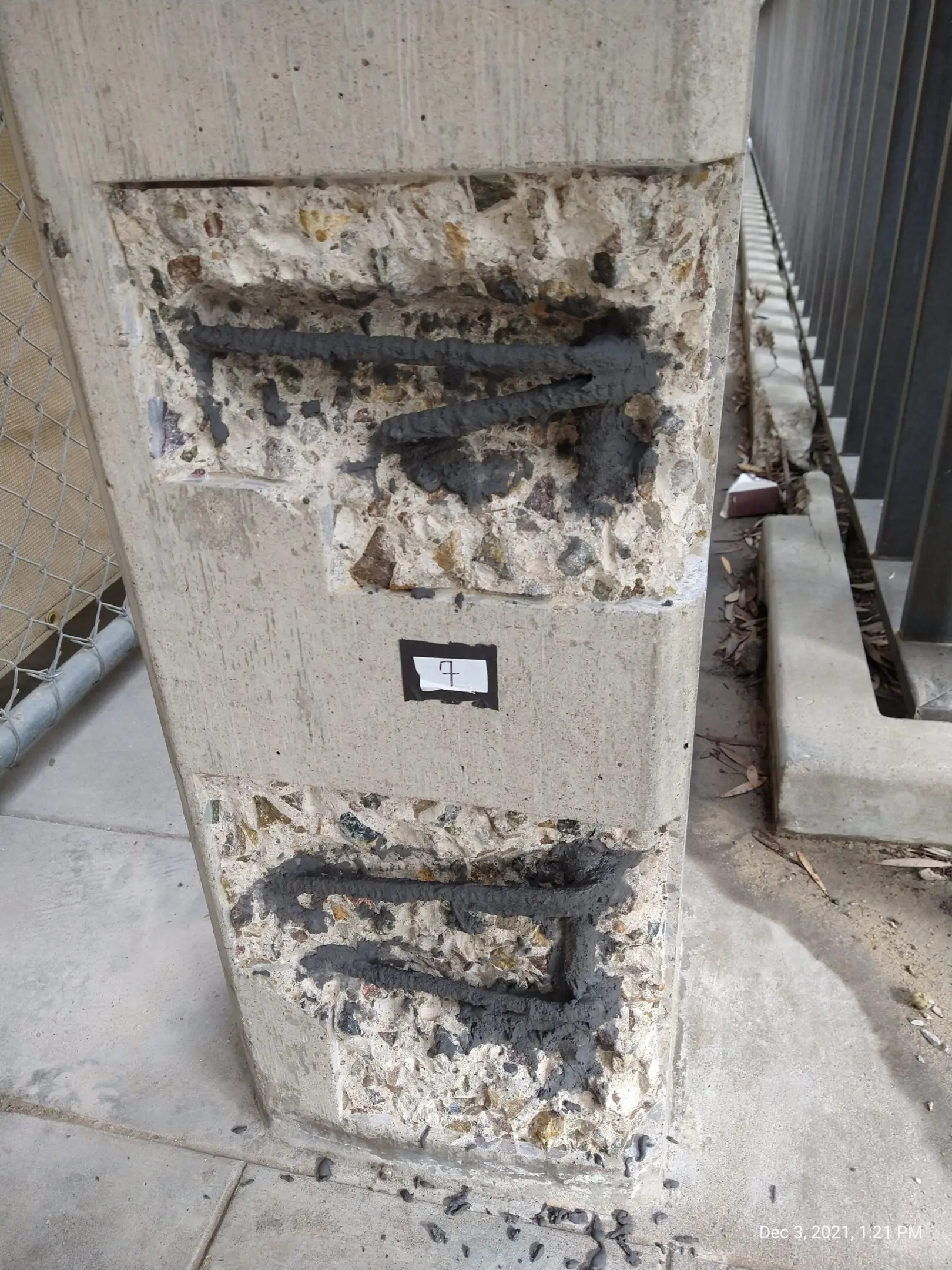 Damaged concrete column showing steel bars