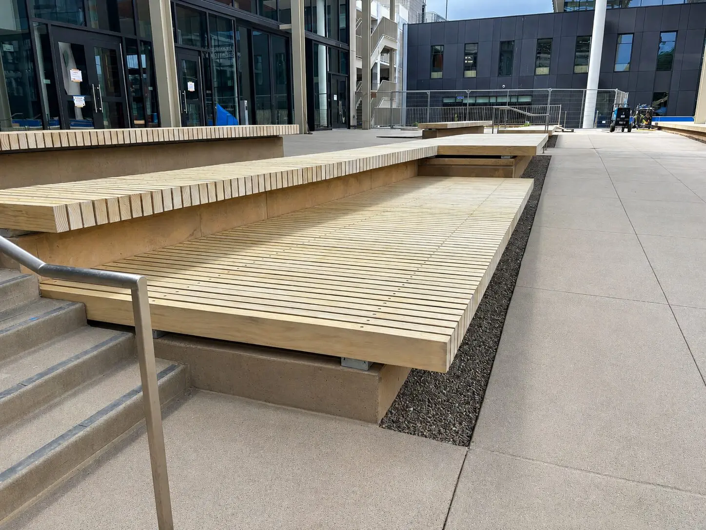 Contemporary wooden benches in urban environment.