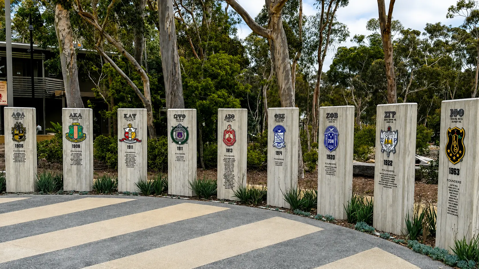 Stone pillars displaying military emblems and dates.