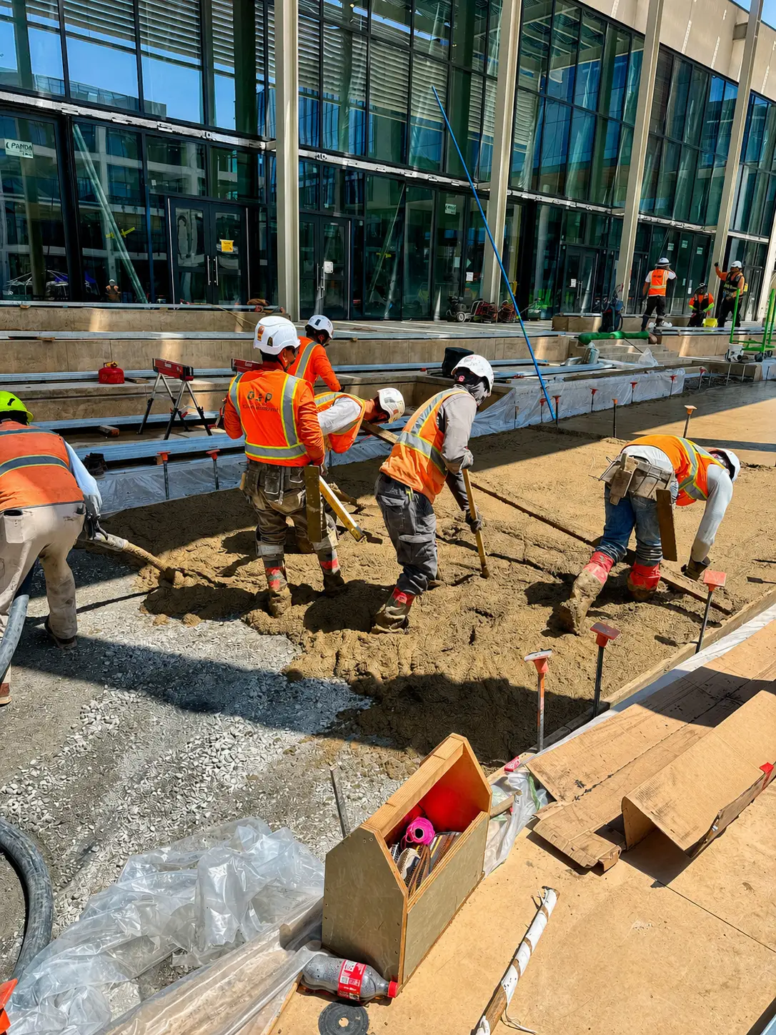 Construction workers shoveling dirt at site