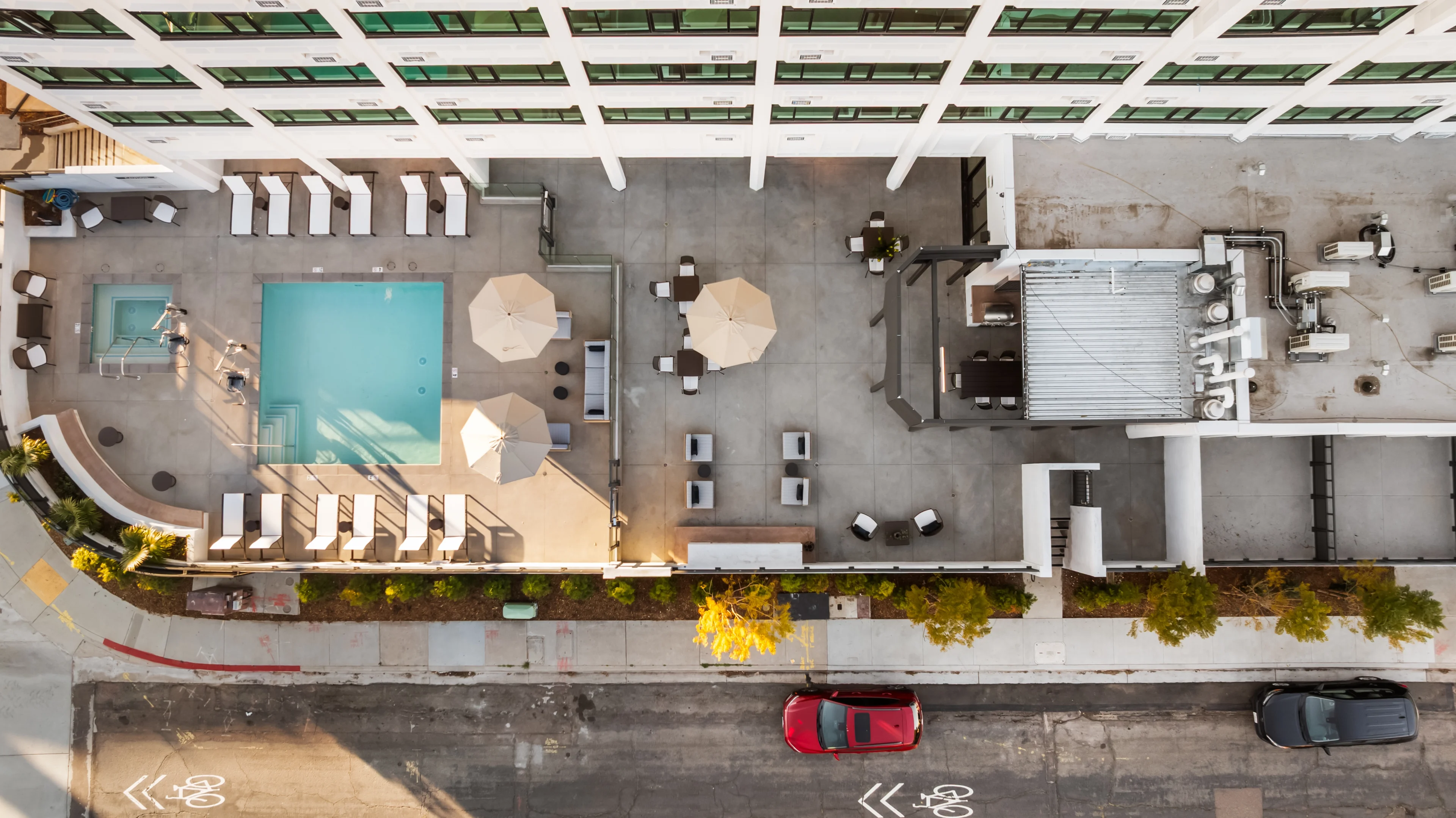 Rooftop pool with lounge chairs and umbrellas
